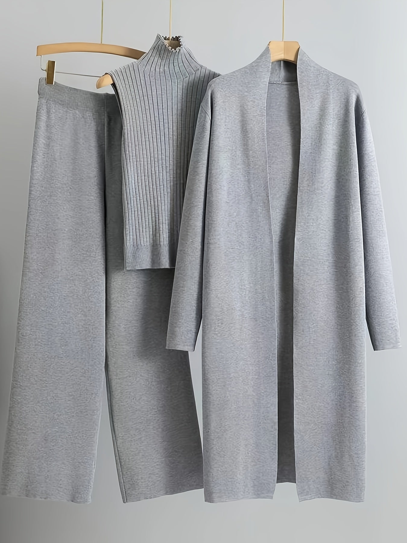 New High-Elasticity Autumn And Winter 2024 Women'S Loose Knit Set Featuring Long Wide-Leg Pants, a Shawl Cardigan, And a Turtleneck Sweater in a Stylish Three-Piece Ensemble.