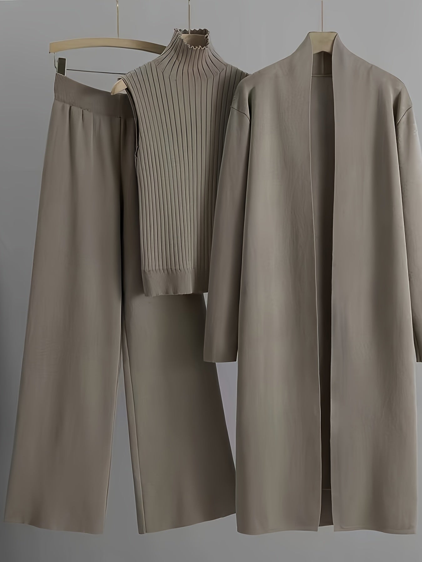 New High-Elasticity Autumn And Winter 2024 Women'S Loose Knit Set Featuring Long Wide-Leg Pants, a Shawl Cardigan, And a Turtleneck Sweater in a Stylish Three-Piece Ensemble.