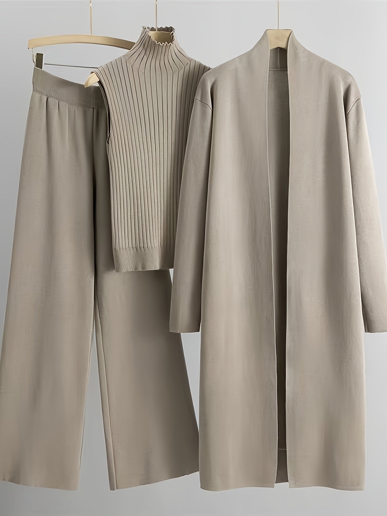 New High-Elasticity Autumn And Winter 2024 Women'S Loose Knit Set Featuring Long Wide-Leg Pants, a Shawl Cardigan, And a Turtleneck Sweater in a Stylish Three-Piece Ensemble.